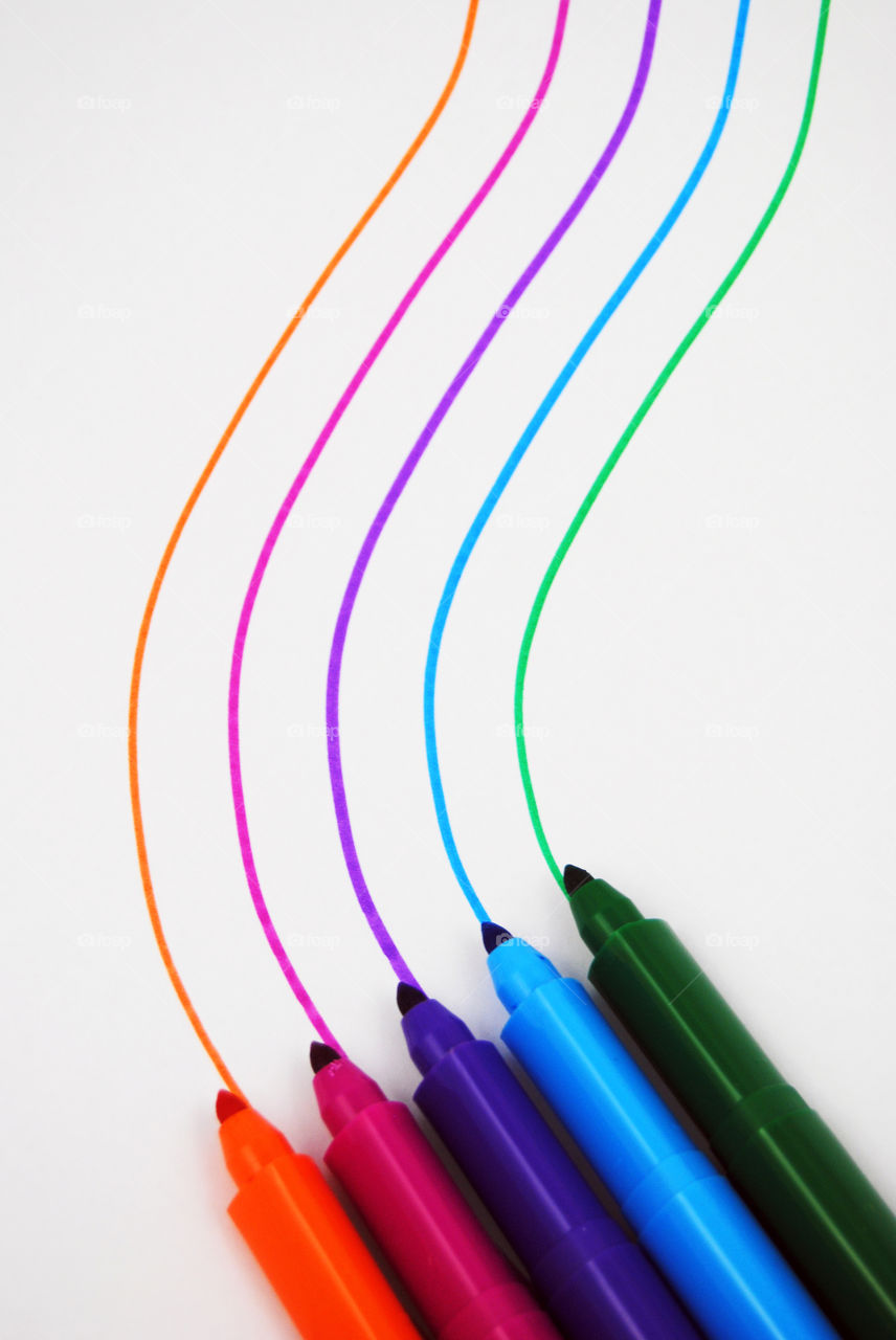 color felt pins with creative curved stripes on white paper