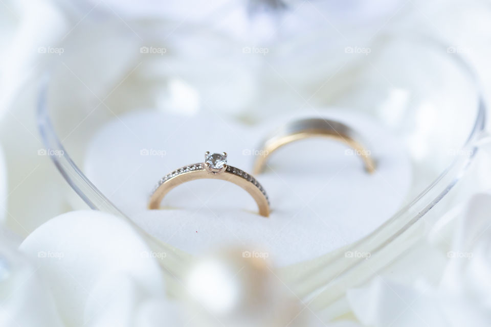 Close-up on wedding rings in a heart-shape box 