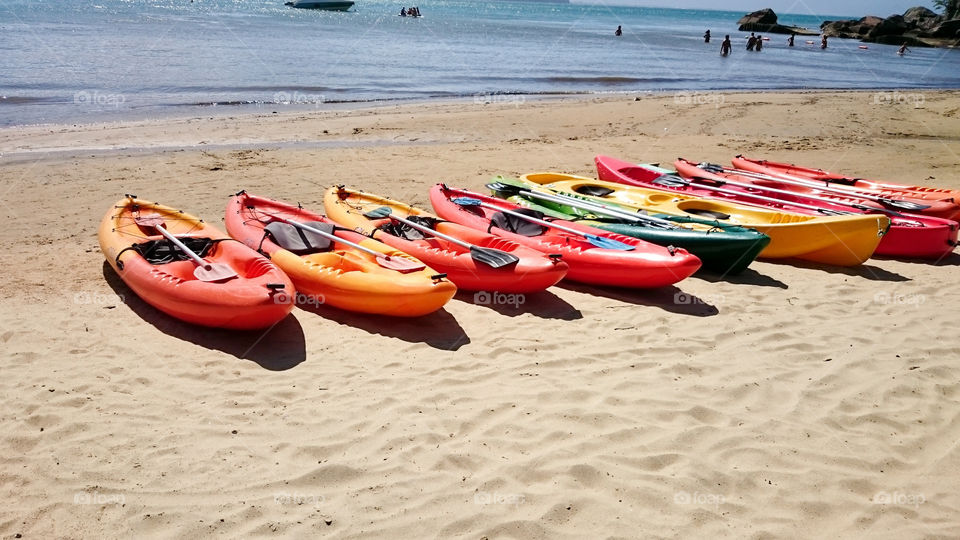 Multi colored kayaks on beach