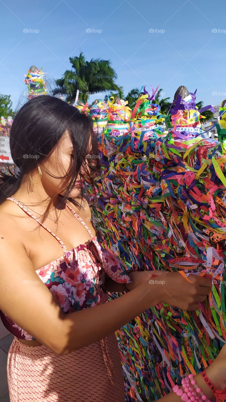 Placing the traditional Senhor do Bonfim bracelet in the Bomfim Church Salvador Bahia Brazil