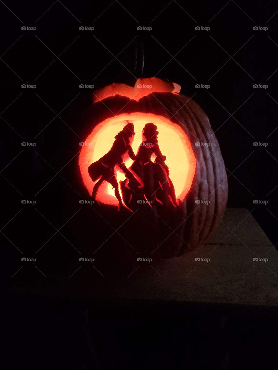 a jack-o-lantern carved to show a colonial couple