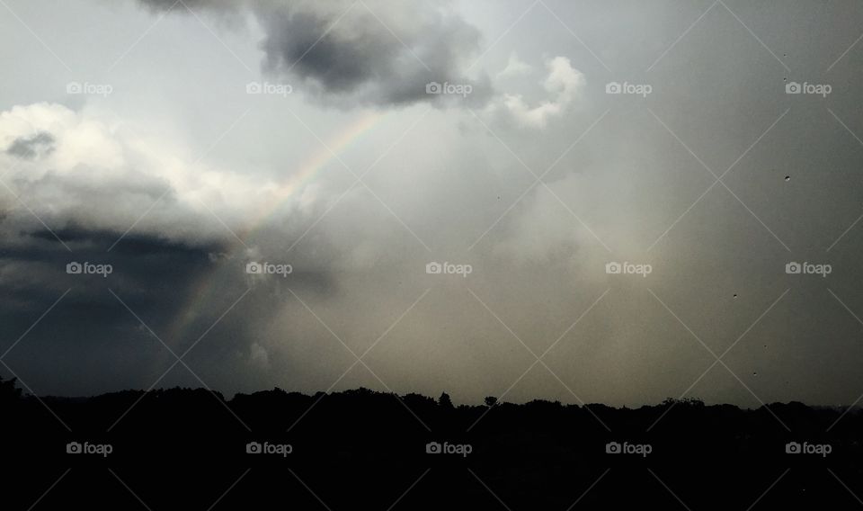 Rainbow through rain storm 