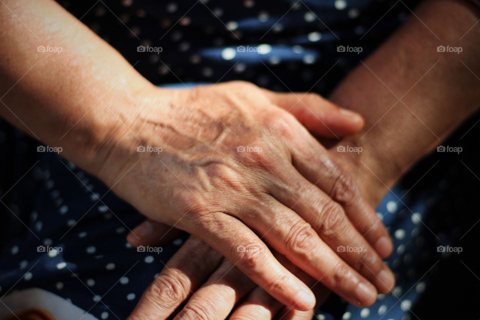 old woman keeping her hand folded waiting