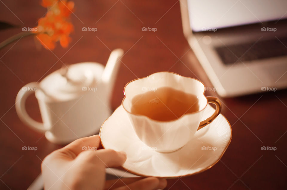 Holding a vintage cup of tea