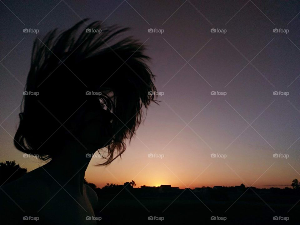 Hair flip on sunset background