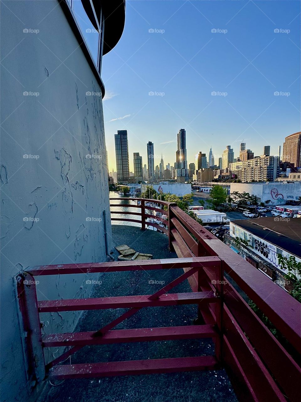 This is the center outpost of the “Pulaski Bridge” at “Newtown Creek” connecting “Greenpoint”, Brooklyn to LIC, Queens. Across the water of the “East River” we see “Manhattan” and the “Empire State Building”. 2024. Hypnotic Productions
