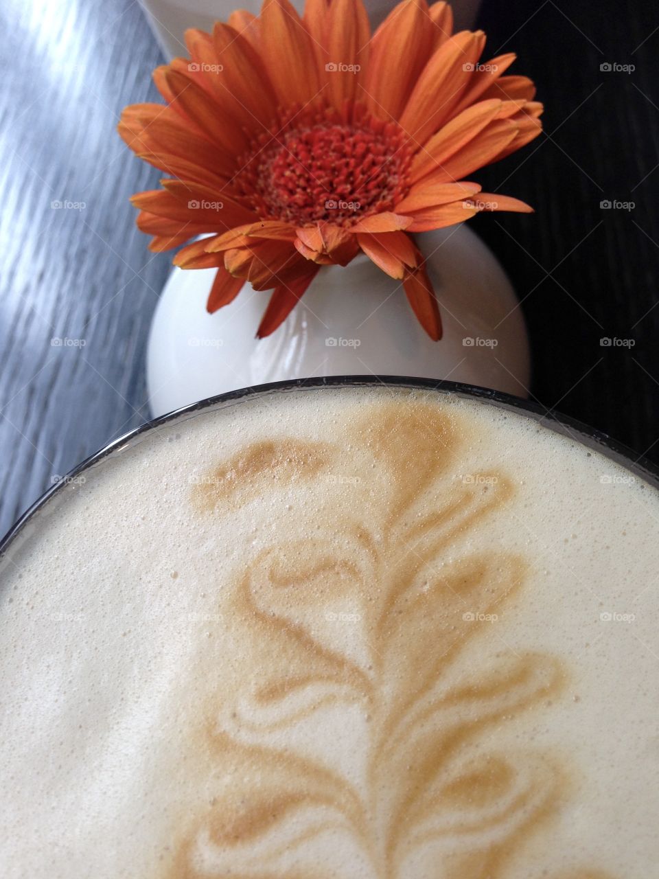 A cup of coffee and flower.