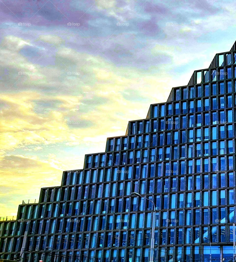 Glass building with sky in the background.