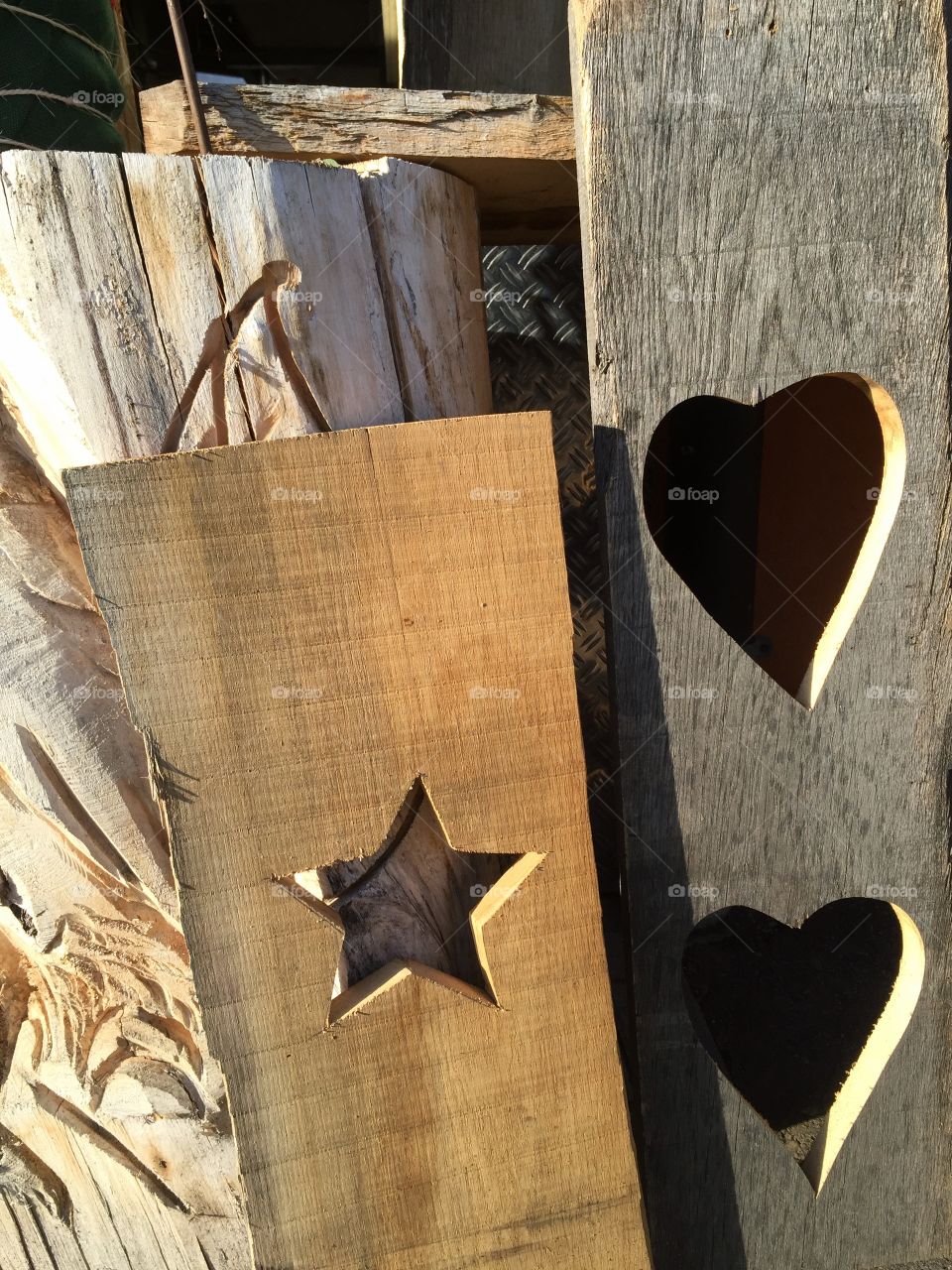 Star and hearts in a piece of wood