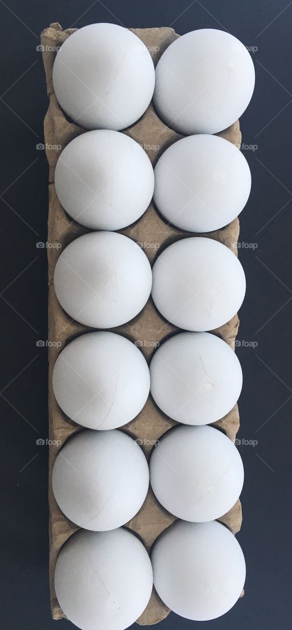 Row of white eggs in carton