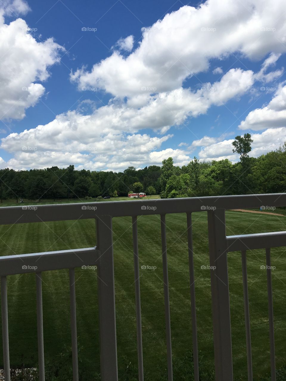 Big clouds, blue skies and green grass