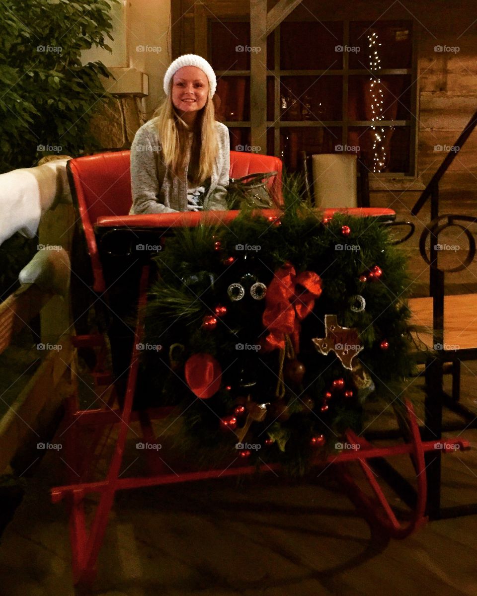 Young woman sitting at patio in christmas