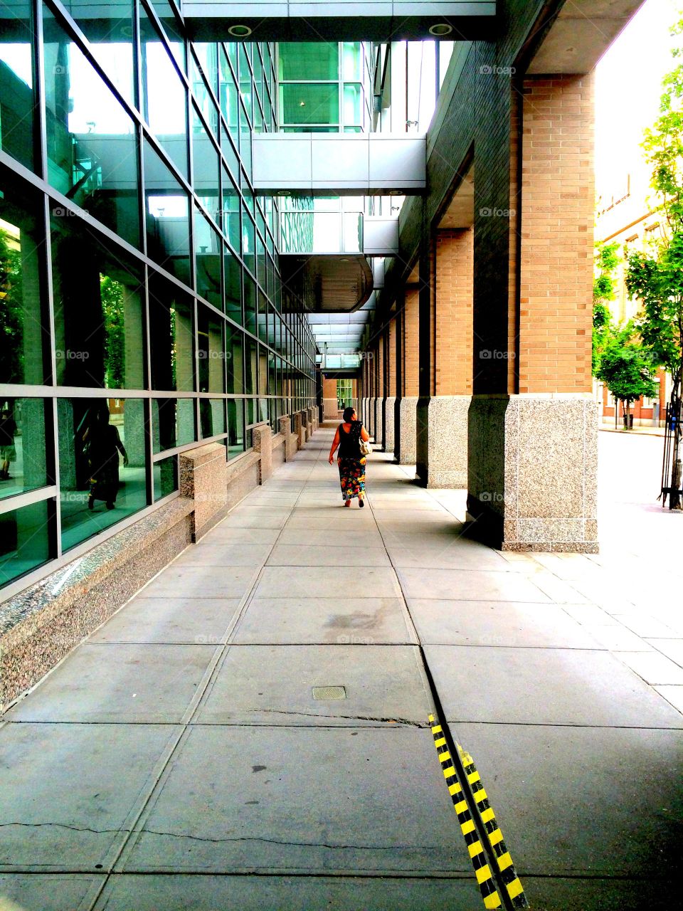 Down the Sidewalk. A woman walks down the sidewalk.