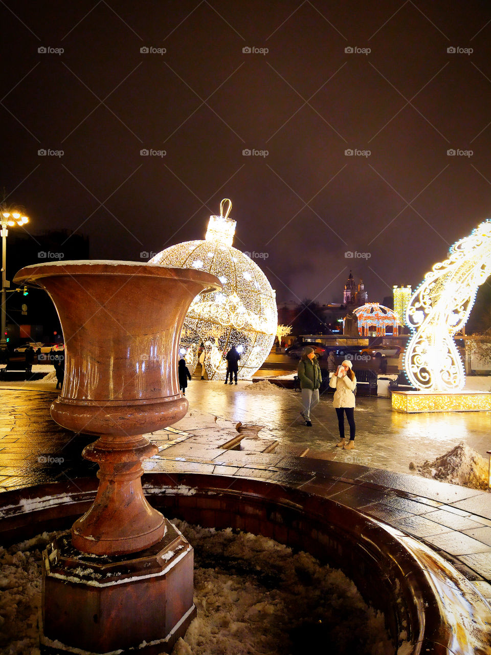 Moscow in the evening.  New Year street decorations.  Figures from glowing garlands in front of the Bolshoi Theater
