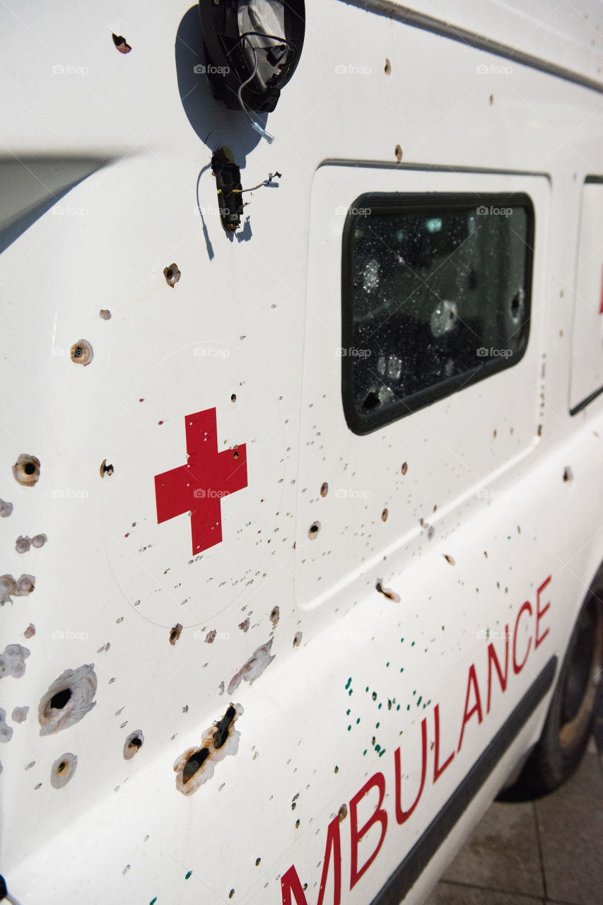 A real ambulance from the Red Cross who had been attacked in war. The Ambulance has bulletholes just everywhere and even firebombs have been thrown against it. The ambulance is part of efforts to make people aware of what happens in war. Ambulance shown up in various parts of the world. The picture is from Malmö Sweden.