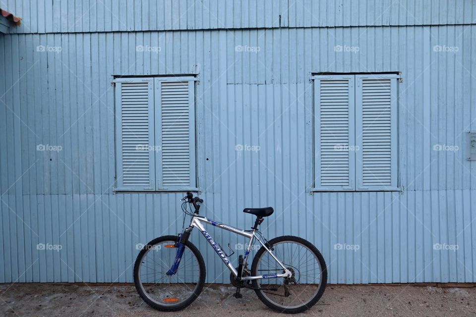 Bicycle in front of blue house