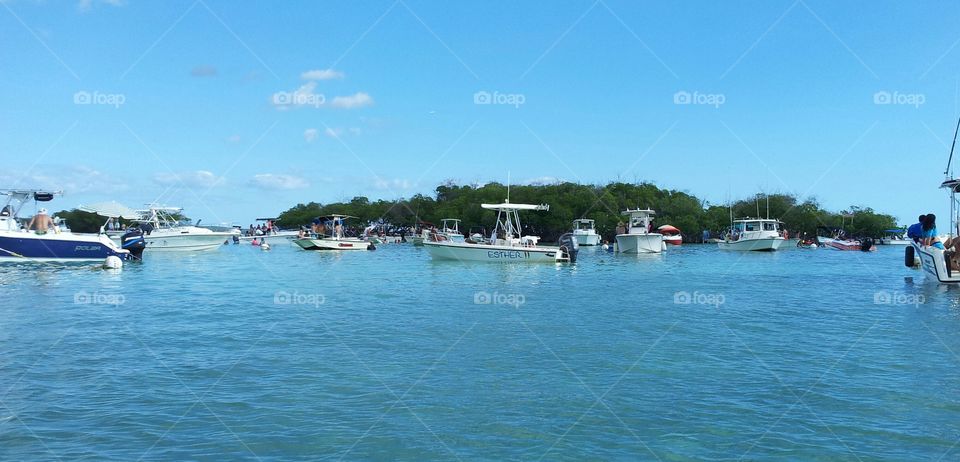 Boats at the sea, in front of an island