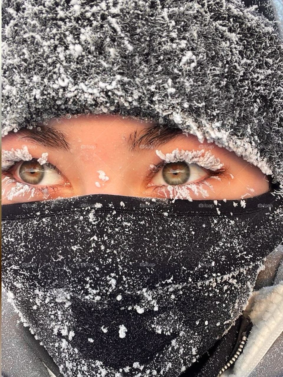 Portrait of a girl with eyes covered in snow