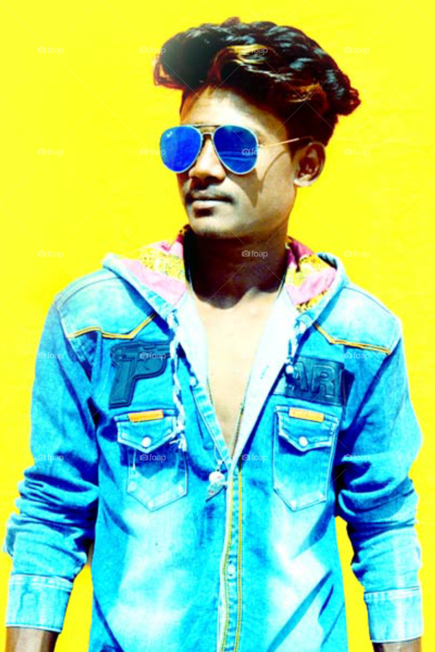 Photo of boy on yellow background /model photo on blue shirt/ beautiful model photo on glasses/a perfect model photo/perfect model photo/indian model photo on glasses/great model photo/model half close up photo/model in new style Photo/good looking