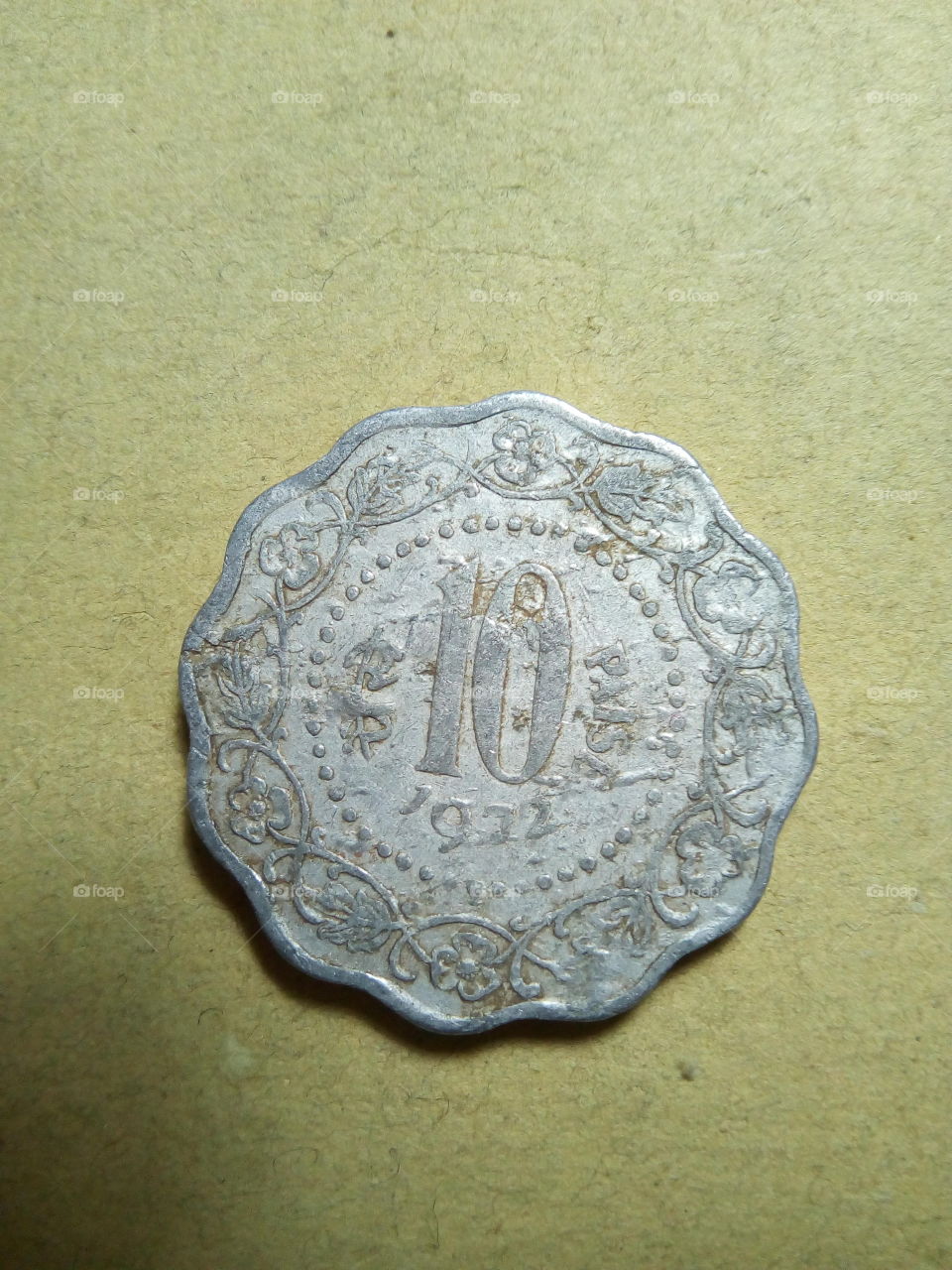 A coin of ten paise- 1/10 share of Indian Rupee issued by Government of India in 1972.