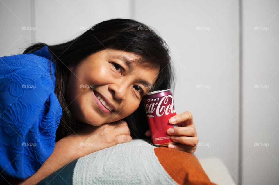 Portrait of a woman holding a Coke soda 