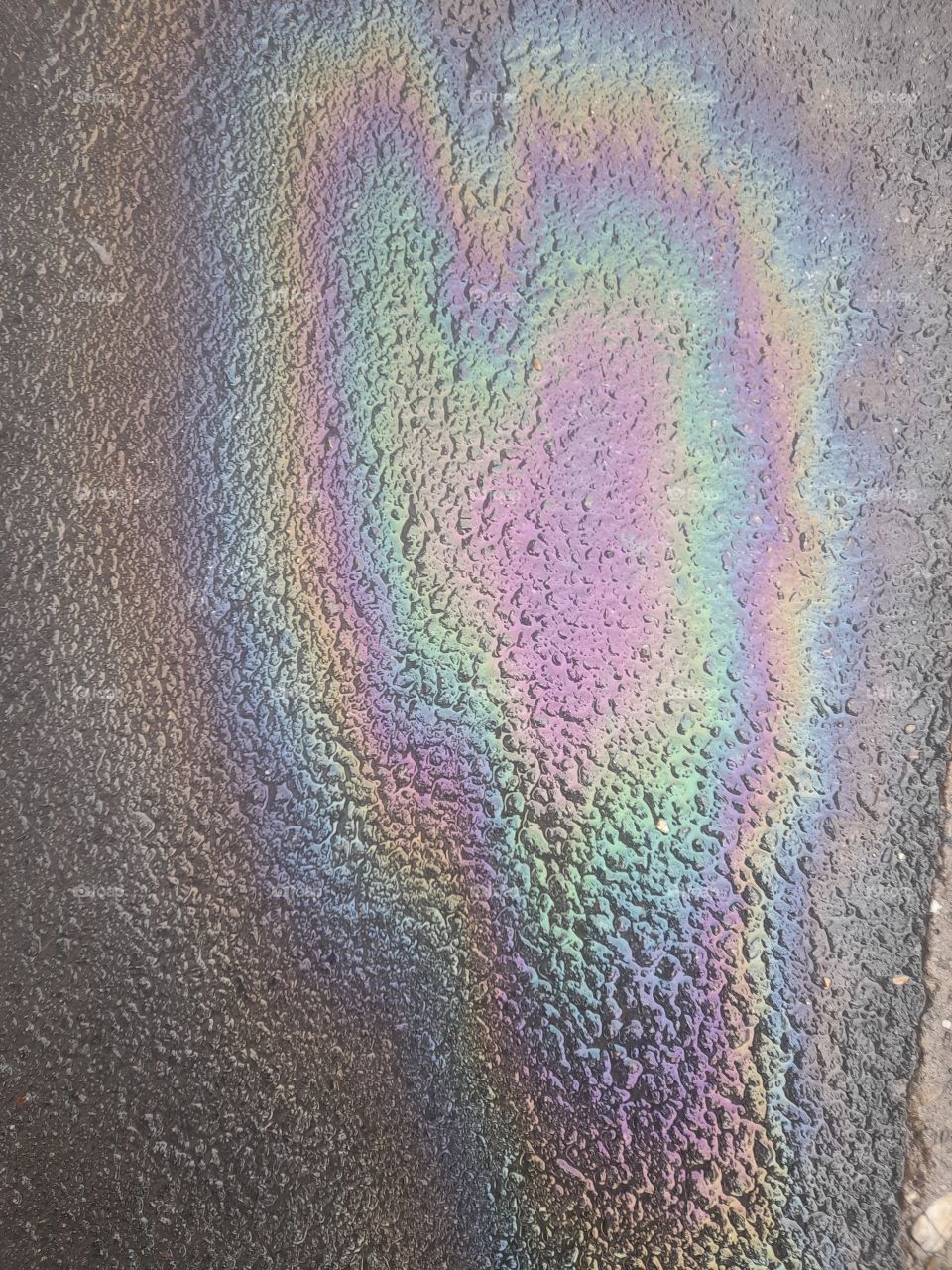 heart from gasoline on sidewalk