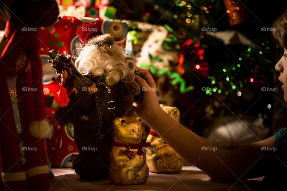Christmas wonder - image of girl playing with Santa Clause with gifts and Christmas gifts in background