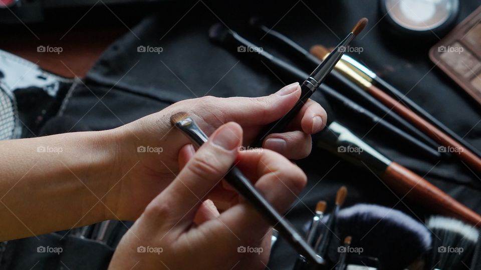 Women holding make-up brush