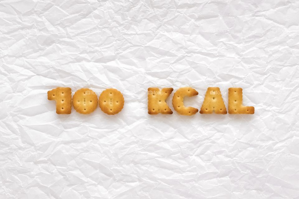 100 kcal, written with crackers, crumpled white baking paper, cookies with a caloric content of one hundred