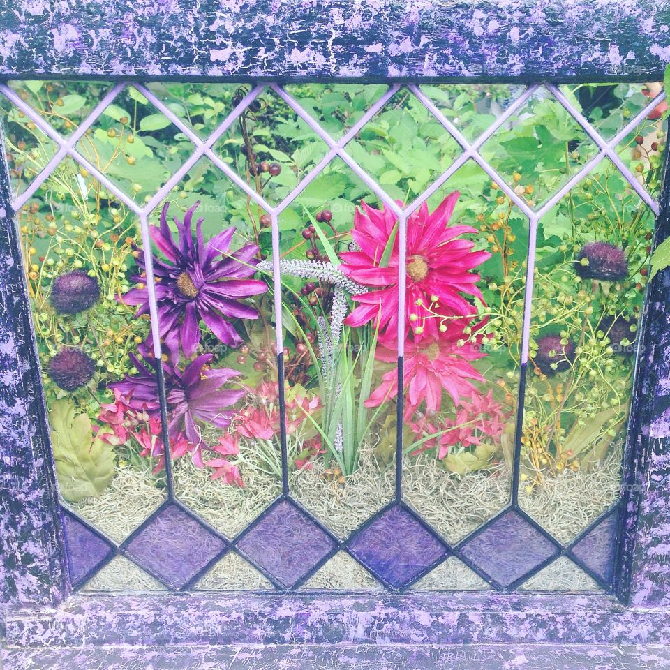 An antique stained glass window doubles as a planter.