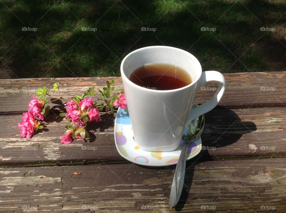 Enjoying a cup of coffee on a beautiful spring day outdoors.