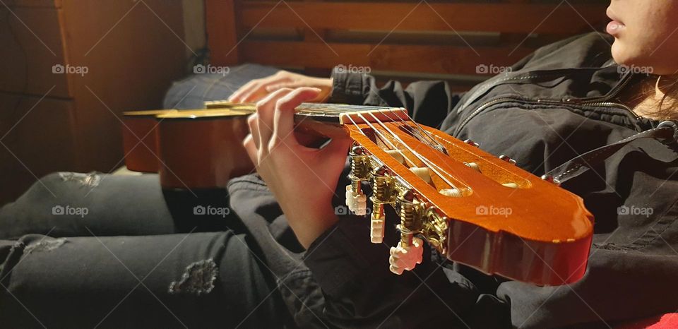 A moment in our personal space, playing the guitar, a very beautiful musical instrument and a spectacular sound