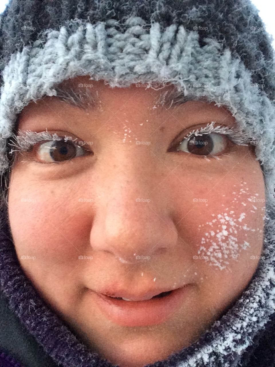 Lady with frozen eye lashes. Close up face. 