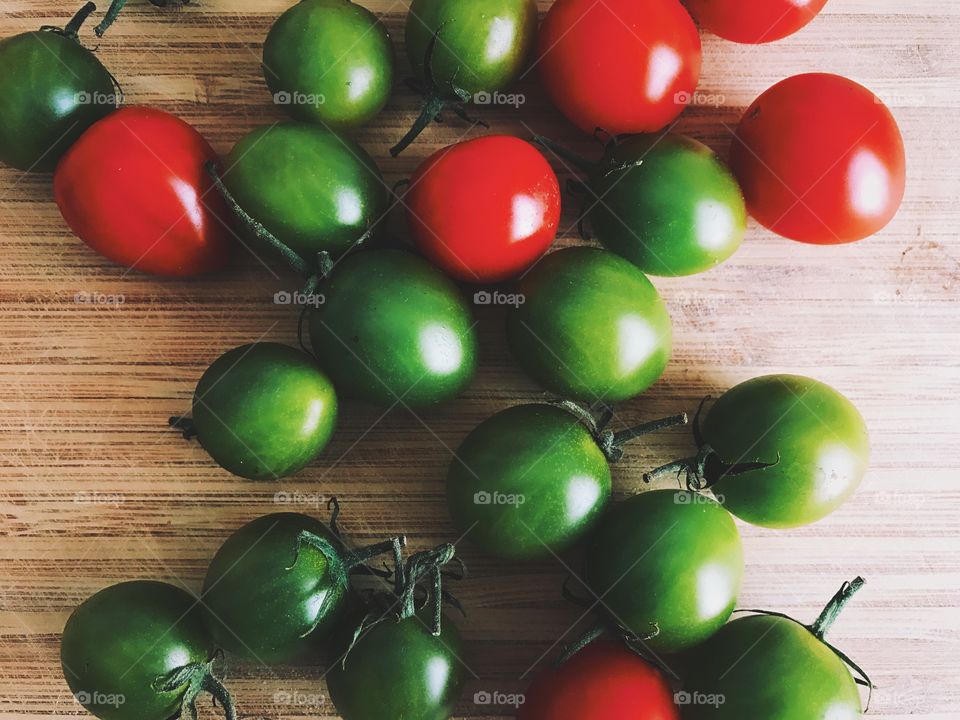 Overhead view of green and red cherry tomatoes. 