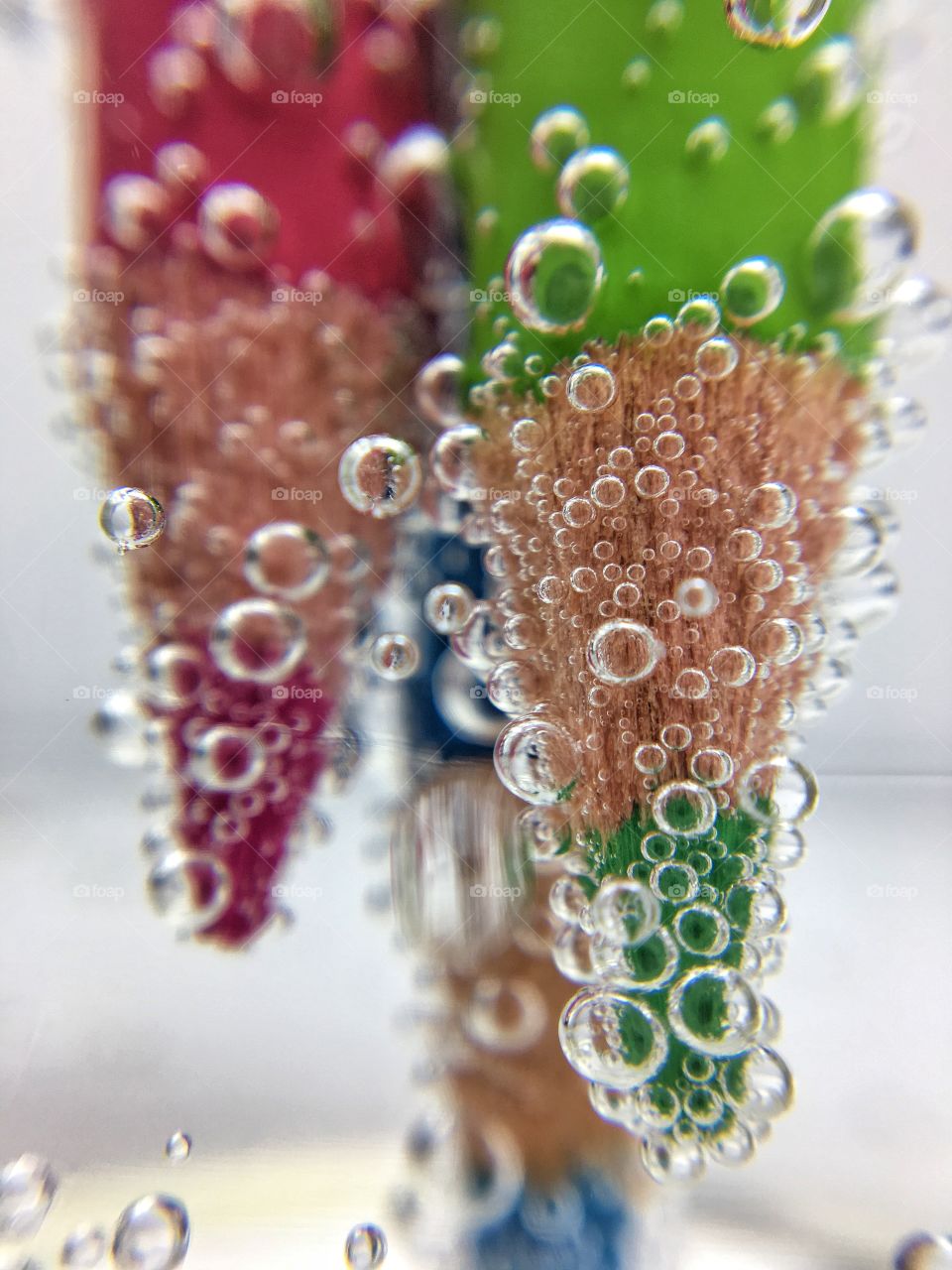 Colored pencil bubbles in water