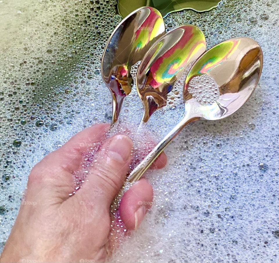 Spoons in dish water