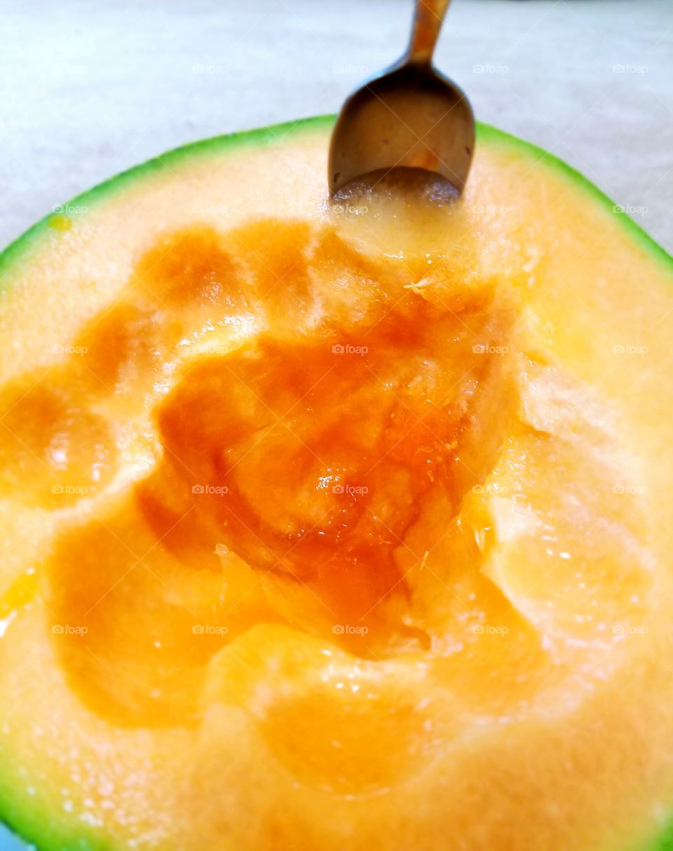 Spoon in melon