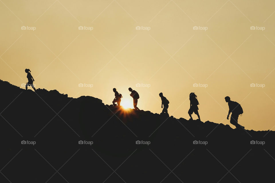People climbing Telica volcano during sunset