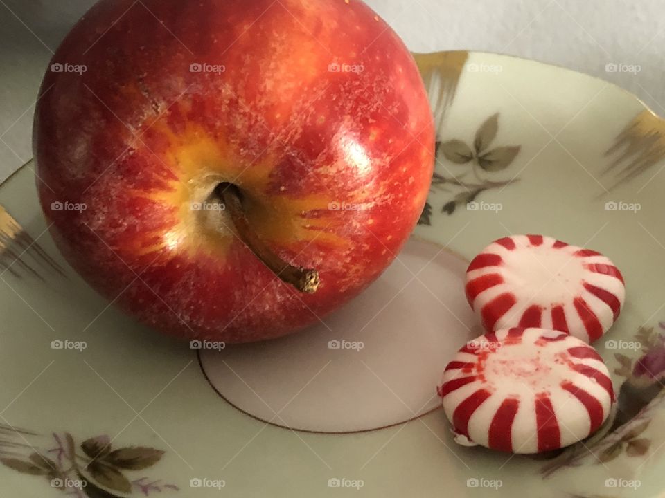 Peppermints and a red juicy apple