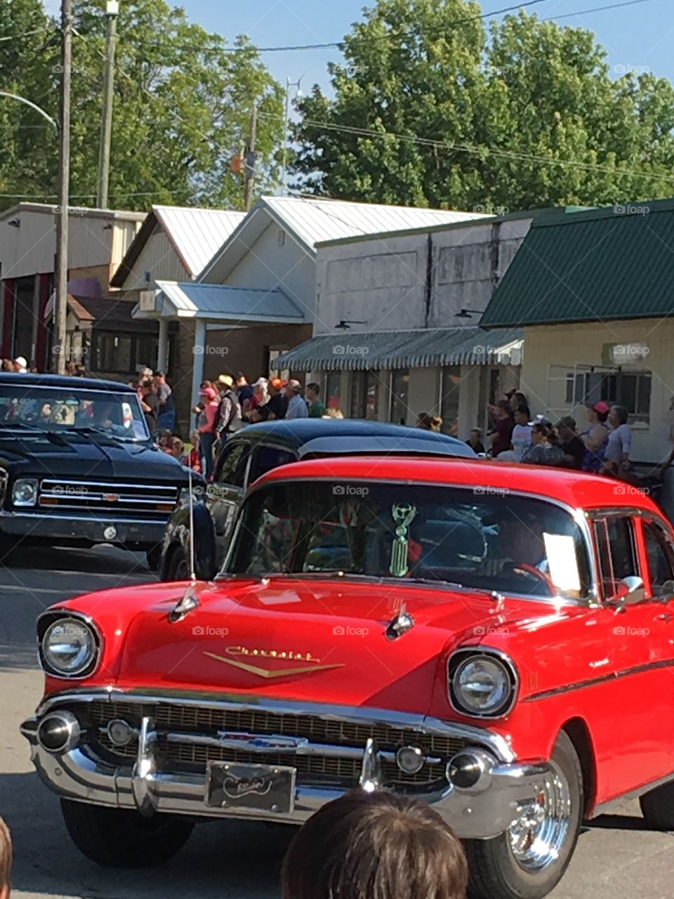 ‘57 Chevy coming around the corner, candy apple red,show room condition.