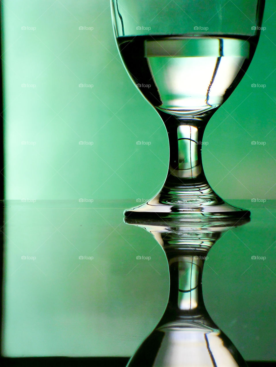 water in water glass or goblet on a reflective table