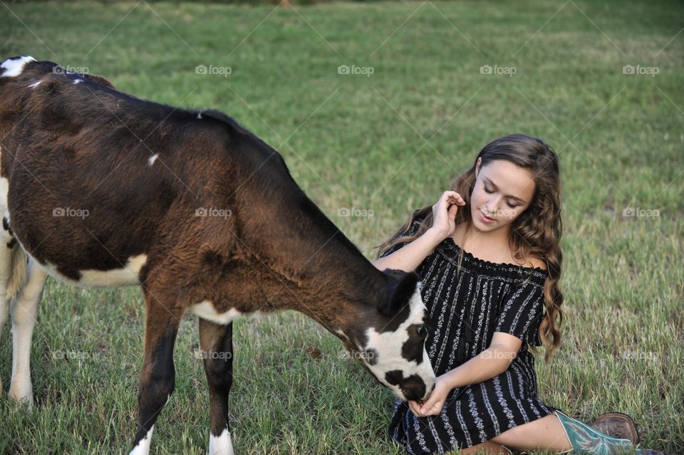 Pretty girl with baby cow 