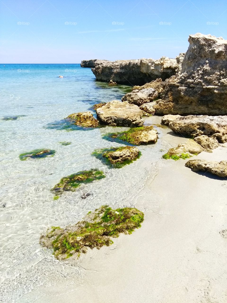 Sea view with rocks in the water on the beach of San Foca, Salento, Lecce, Puglia, Italy