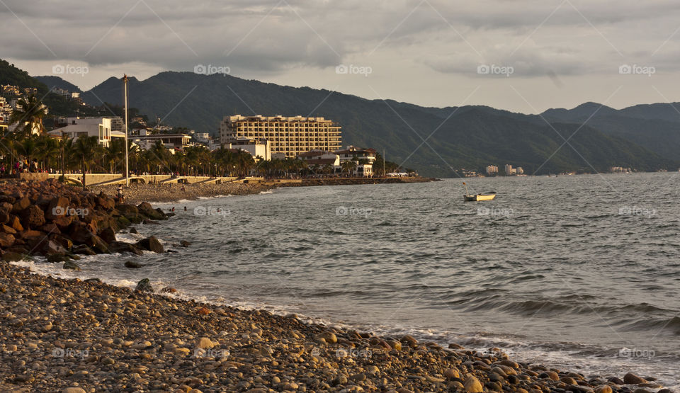 Friday evening on the Malecon in Puerto Vallarta. I slipped away from the carnival of the boardwalk for the relative quiet of the small beach in front of it to take a rest. I took this shot. Then back into the river of people flowing down the boardwalk amongst the shops and vendors I went.