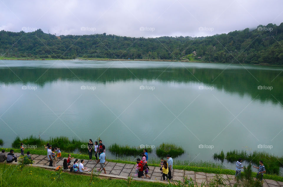 The lake's uniqueness is its green surface formed in the reflections of trees and green leaves surrounding the lake. It's the family's favorite place to relax