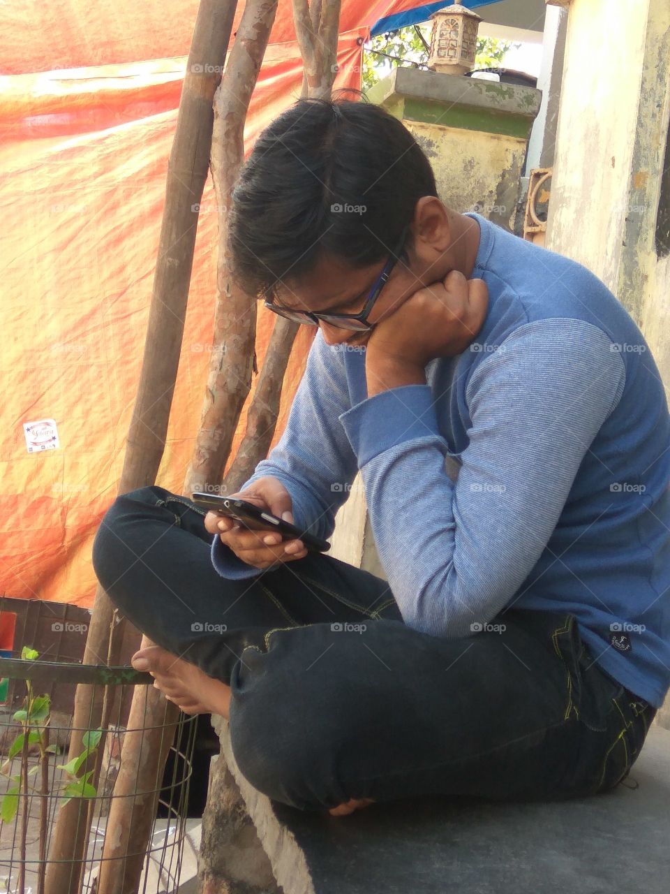 Man sitting with mobile phone in hand