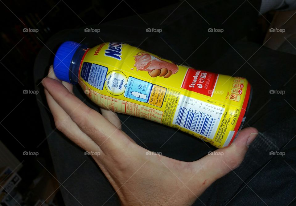 hand holding small bottle