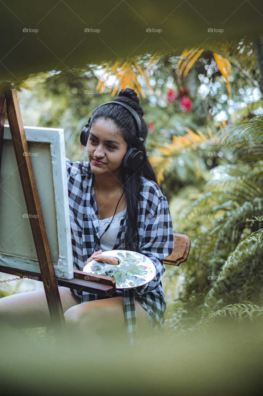 Girl enjoying what she likes best. Girl painting