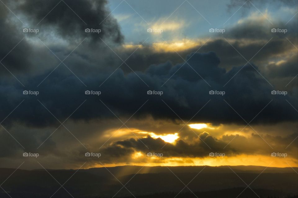 Sun beams through the storm clouds