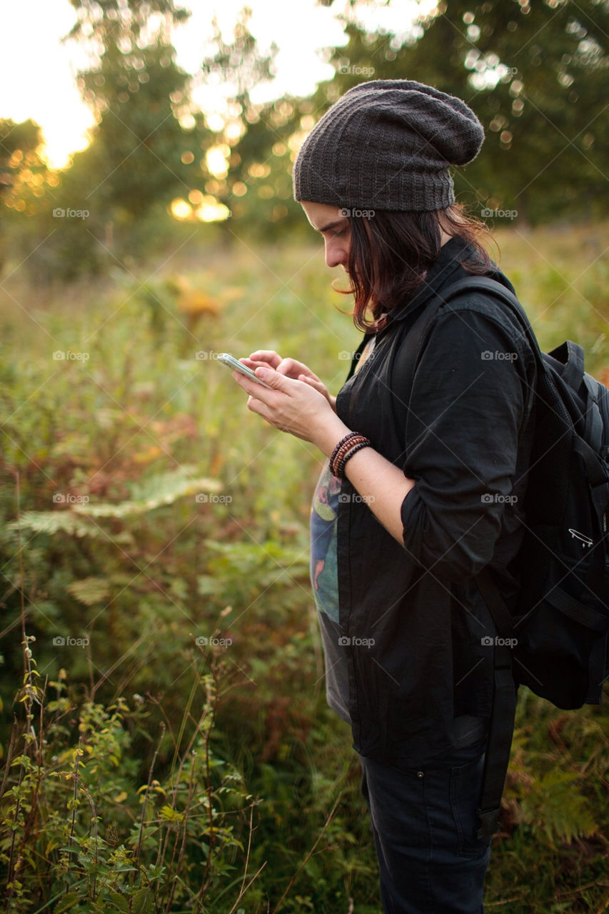 Man is using his phone in the nature